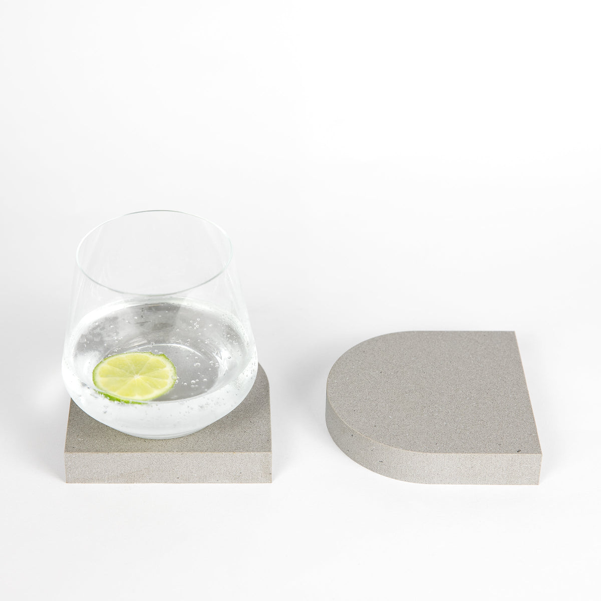 Grey arched stone quartz coasters in Sleek Concrete™ by Aureliia Collection Australia. These  grey quartz coasters have a cork backing. marble coasters in appearance however quartz has greater scratch resistance and is lower maintenance. caesarstone quartz  