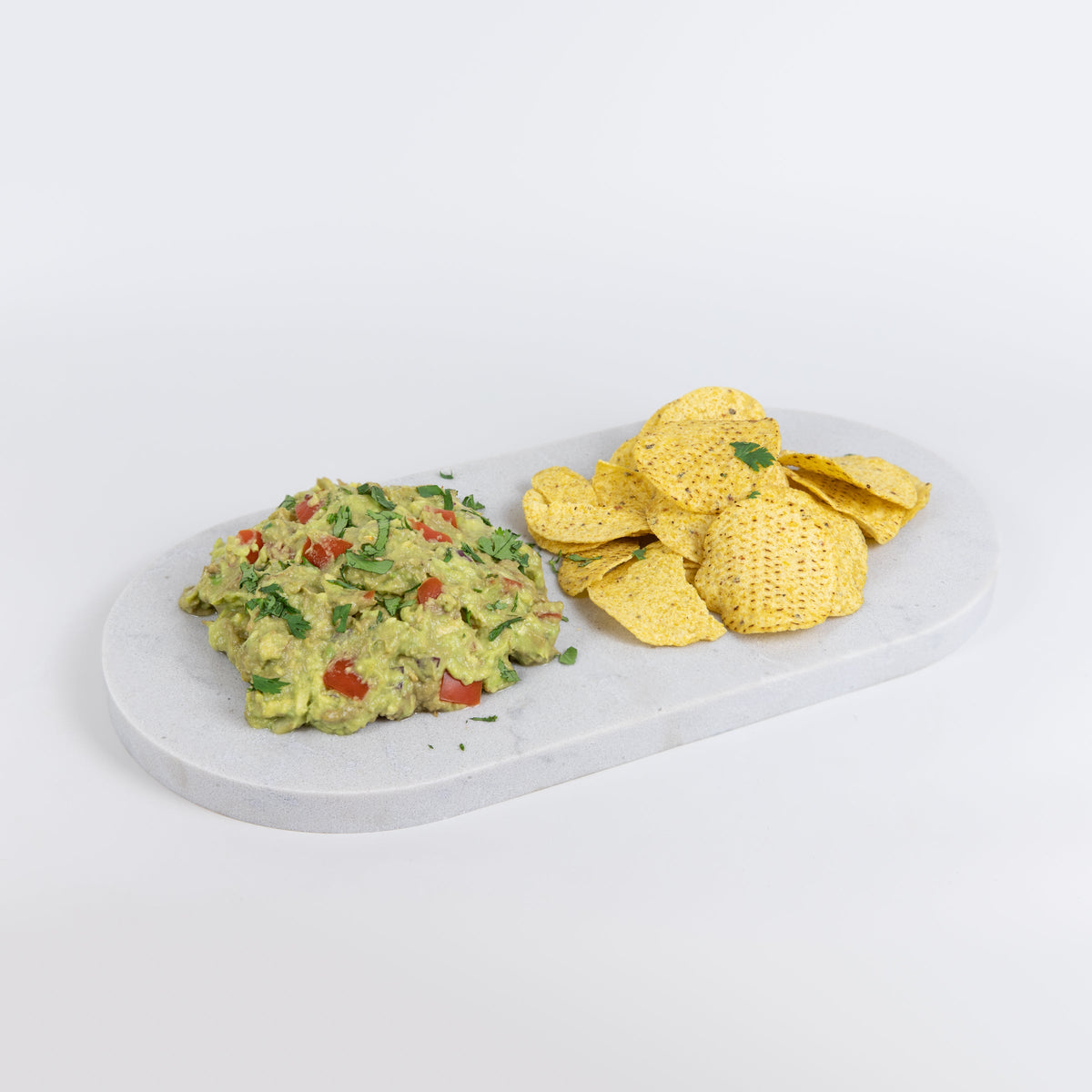 Double arch quartz platters in Caesarstone Georgian Bluffs™ created by Aureliia Collection. The Double arch quartz platter shown with corn chips and home-made guacamole. An excellent home decor gift for someone who has it all.