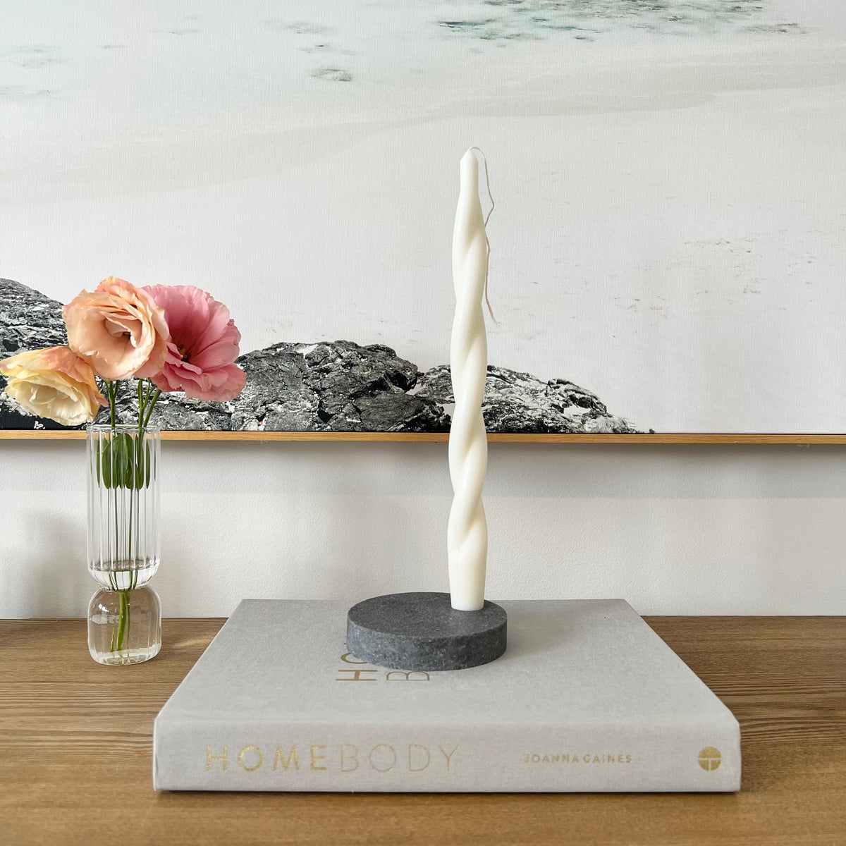 Quartz Round Single Candle Holder in Caesarstone Rugged Concrete created by Aureliia Collection. Styled with Studio McKenna Chunky  Twist Taper pillar candle. This candle holder has dramatic gradients of robust greys, flashed with white-haze patinas and accentuated with industrial-inspired imperfections. The perfect home decor item.