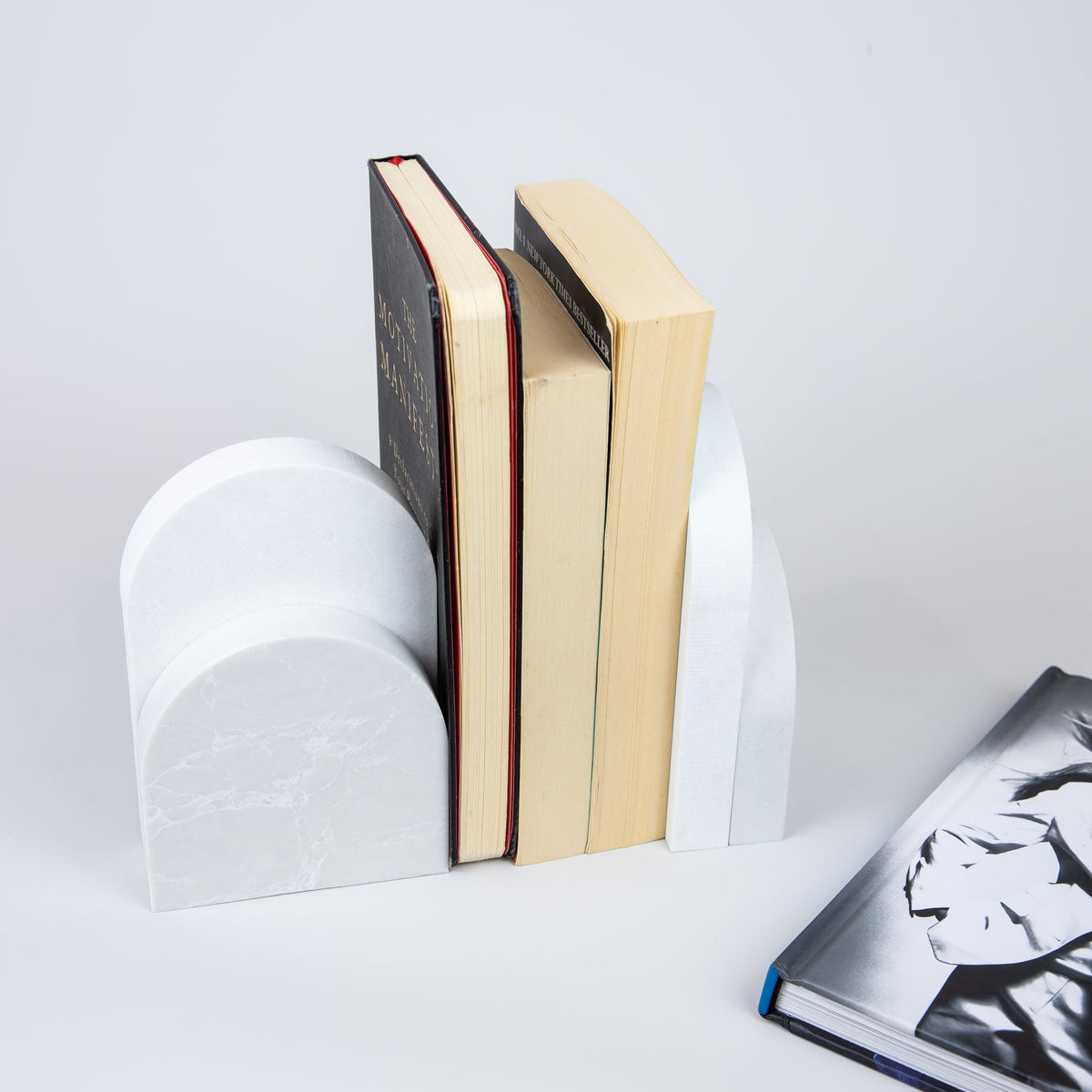 Quartz Bookend Set is 4cm thick. Styled with books. Available in Alpine Mist partnered with Organic White by Caesarstone a cool grey background with delicate crisp white veins, meets a clean white surface with subtly blended undertones, reflecting a natural appearance that is effortlessly chic. The perfect addition to your home decor, similar to marble bookends.