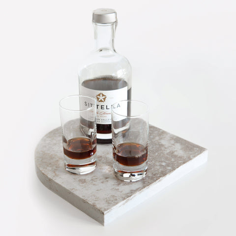 Quartz Arch Platter in Caesarstone Excava™ created by Aureliia Collection. Styled with Sittella Pedro Ximénez NV SOLERA, shot glasses. This decorative quartz serving platter is unpolished with auburn, chestnut, and sweeps of copper. Platters are functional multipurpose items made from quartz which is more resilient and scratch proof in comparison to marble platter.