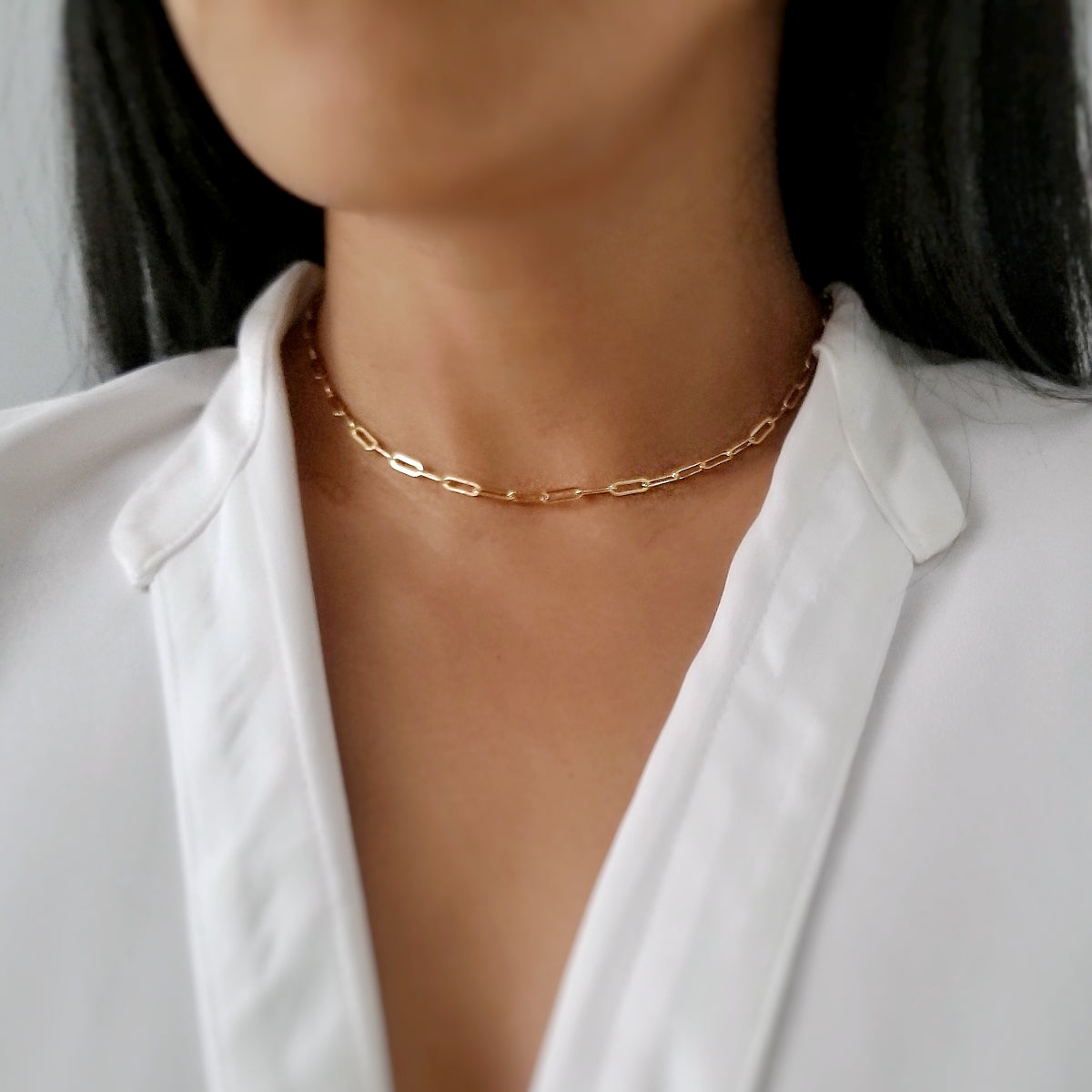 model wearing gold linked necklace